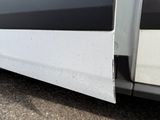 a close up of a white van with a black stripe