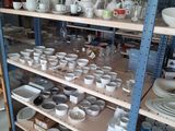 many bowls and cups on the shelves in the room