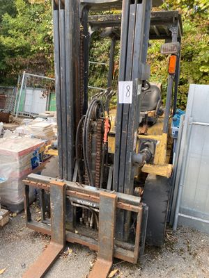 a fork lift truck that is parked in a lot