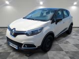 a white car parked on a checkered floor in a garage