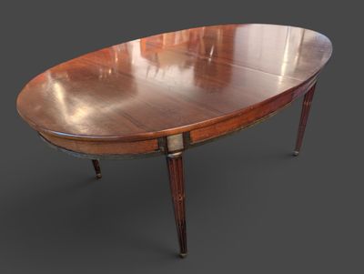 une table à manger ovale avec deux rallonges fixées aux pieds