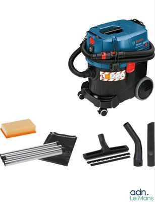 the vacuum is blue and has a cleaning kit on top of it
