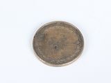 an image of a small coin on a white surface