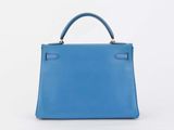 a blue leather handbag on a white background