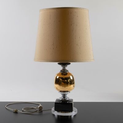 a lamp that is sitting on a table with a lamp shade on it