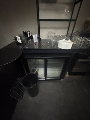 a black counter with a glass door and a wine cooler