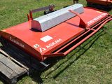 a red machine that is sitting in the grass
