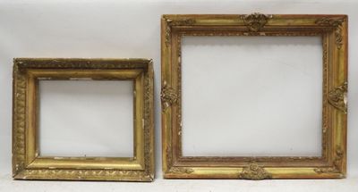 two gold picture frames on a white surface with a white background