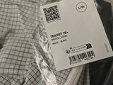 a label on the back of a shirt that is wrapped in plastic