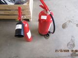 two fire extinguisors sitting next to each other on the floor