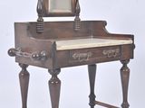 a small desk with a mirror on top of it