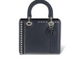 a black handbag with studded handles on a white background