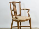 an image of a wooden chair with a beige upholstered seat