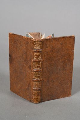 an old book that is open on a table