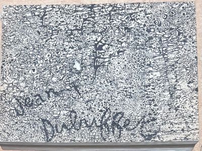 a black and white picture of a laptop with graffiti on it