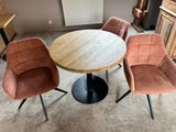 three chairs around a round table in a living room