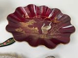 a red plate with a picture of two birds on it