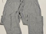 grey sweat pants with pockets on a white surface