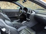 the interior of a sports car with black leather seats and a steering wheel