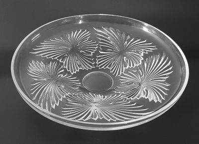 an old glass bowl with a flower design on it