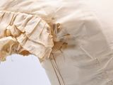 a close up of a white dress with ruffles on it
