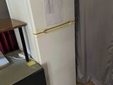 a refrigerator and a freezer in the corner of a room