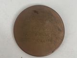 an image of a bronze medal with a message on it