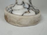 a white marble vase with a black and white design on it