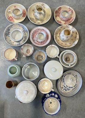 de nombreux types de tasses à thé et de soucoupes sur la table