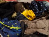 a pile of clothes that is sitting on the floor