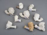 many pieces of white clay on a gray surface