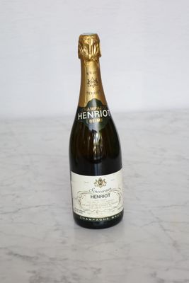 the bottle of champagne is sitting on a marble counter top