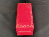 a small red box with a gold design on it