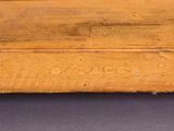 a close up of a piece of wood with writing on it