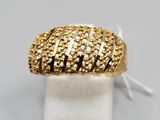 a close up of a gold ring on a white surface