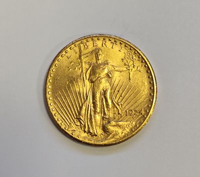 a close up of a gold coin on a white surface