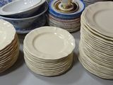 a lot of plates and bowls on the table