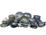 a pile of blue and white plates and bowls