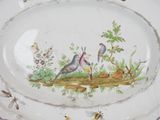 a picture of a plate with birds and flowers painted on it