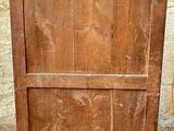 an old wooden cabinet with a door on it