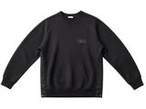 a picture of a black sweatshirt with a small patch on the chest