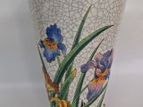 an image of a vase with flowers painted on it