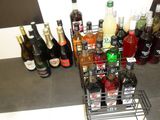 many bottles of alcohol on the counter next to each other