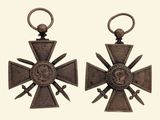 pair of bronze crosses with swords and a medallion on each of them