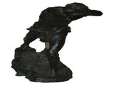 statue of a man on a rock holding a baseball bat