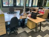 a desk with two computers and a printer on it
