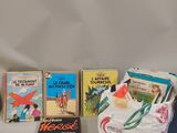 several children ' s books are lined up on a table