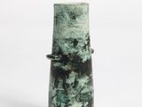 a green vase that is sitting on a white surface