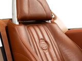 a brown leather car with a tv in the back seat