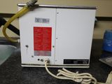 a white machine with a yellow hose hooked to it